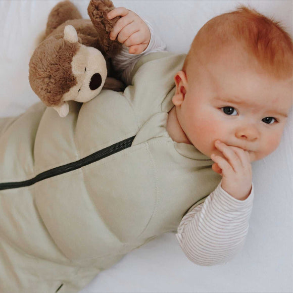 Baby wearing Tyngdeposen® Baby soothing sleep sack with teddy bear.