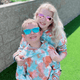 Kids wearing colorful, polarized sunglasses with UV protection outdoors.