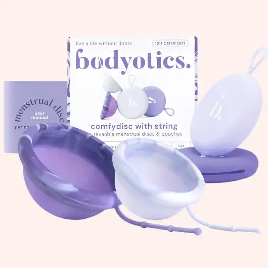 Bodyotics Comfydisc reusable menstrual discs in purple and white with carrying pouches and packaging for eco-friendly, leak-free period protection.